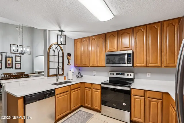 a kitchen with granite countertop cabinets stainless steel appliances and a sink