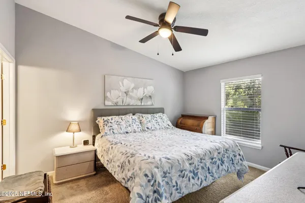 a bedroom with a large bed and a window
