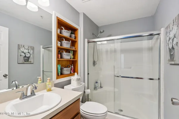 a bathroom with a sink toilet and shower