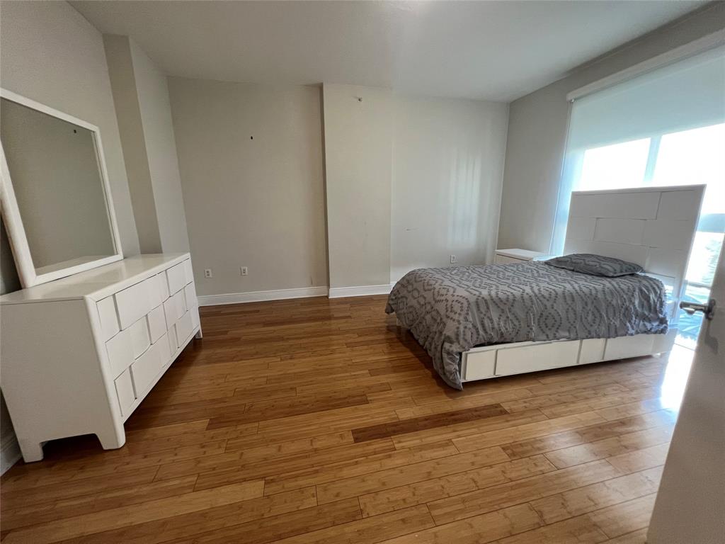 7275 Southwest 89th Street, Unit B520 Miami, FL 33156 - Photo 11 of 26 a bedroom with a bed and wooden floor