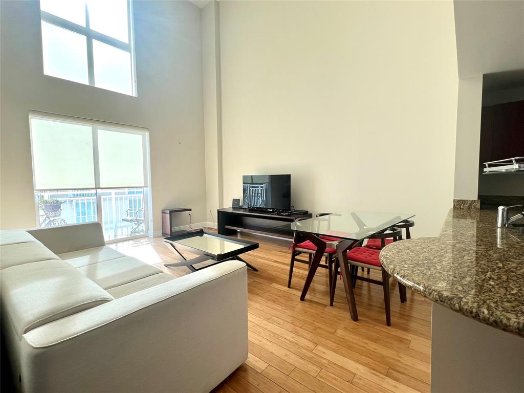 7275 Southwest 89th Street, Unit B520 Miami, FL 33156 - Photo 6 of 26 a living room with furniture and a flat screen tv