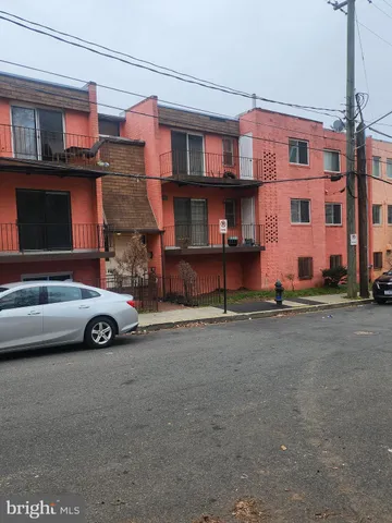 a view of a car is parked in front of a building