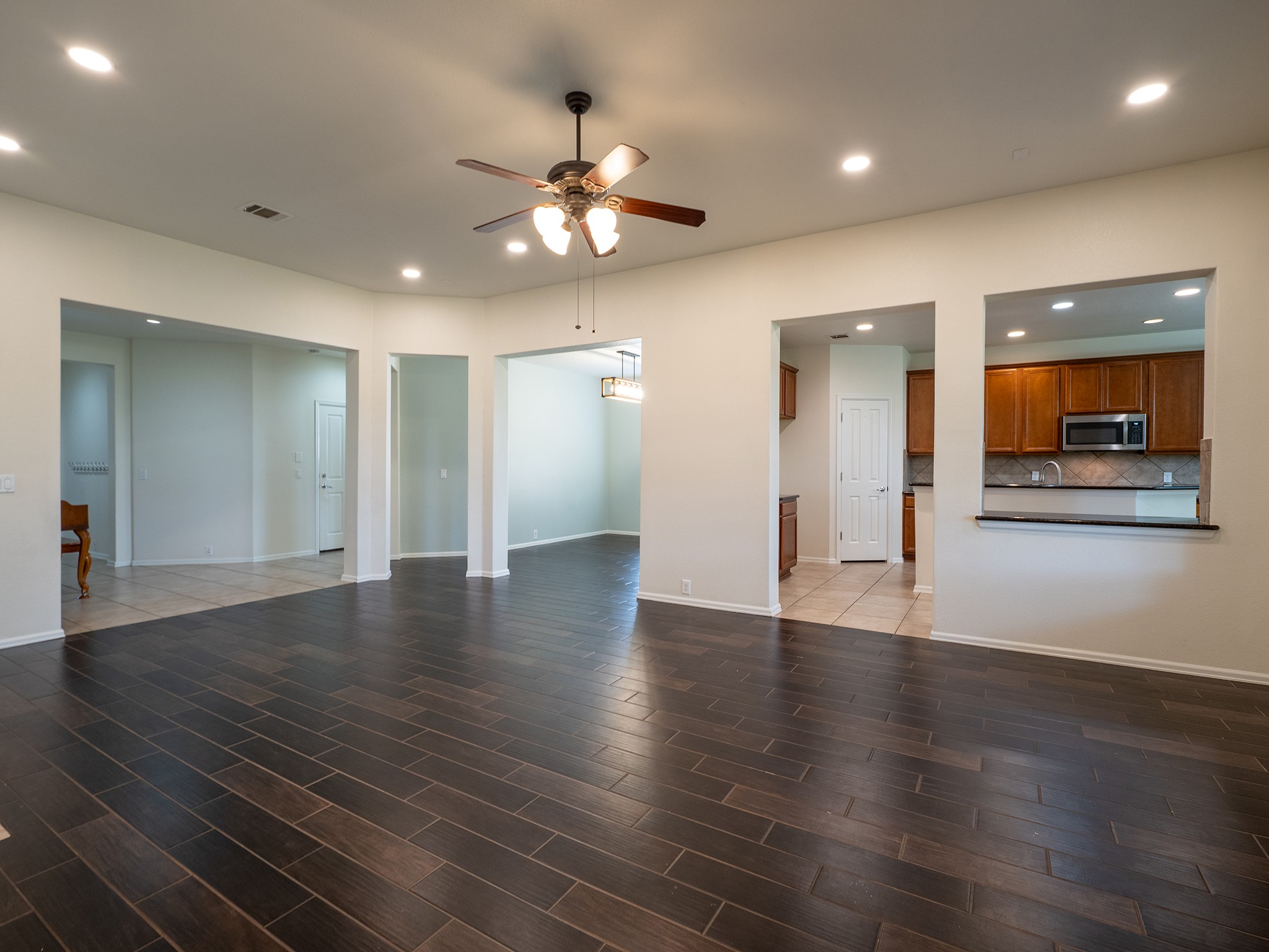 572 Big Meadow Road Austin, TX 78737 - Photo 32 of 32 An open floorplan offers rich, dark tile flooring and recessed lighting.
