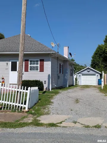 a view of a house with a yard and fence
