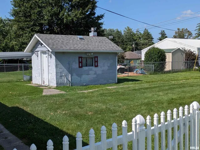 a front view of house with yard and trees
