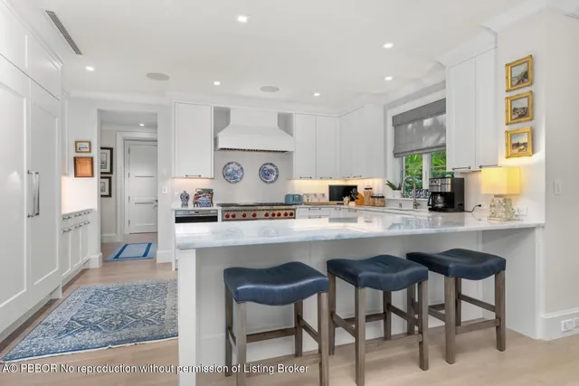 a kitchen with stainless steel appliances granite countertop a sink and a refrigerator
