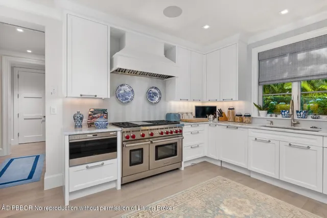 a kitchen with a stove a sink and a refrigerator