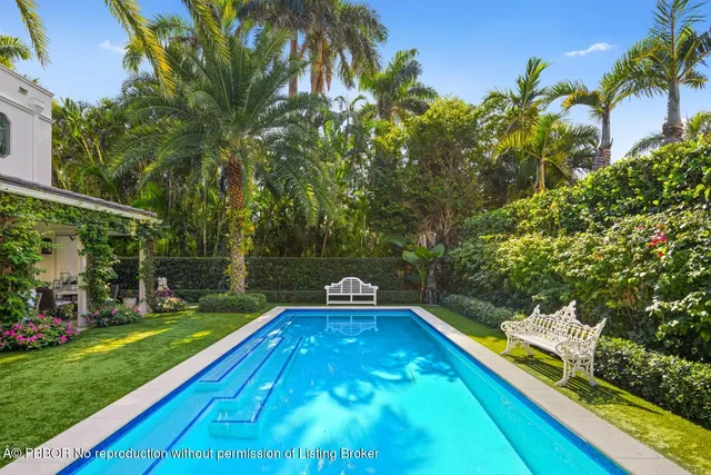 a view of a yard with swimming pool
