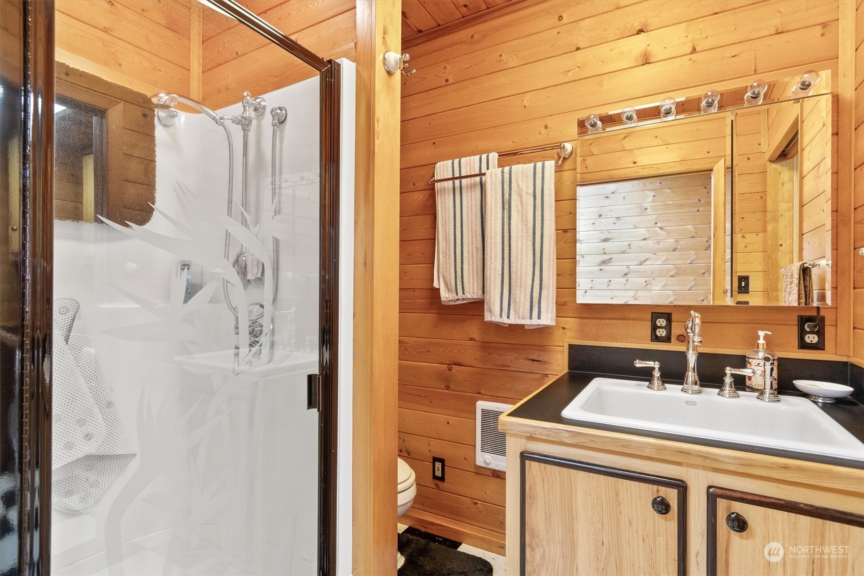 115 Don Martin Road Longview, WA 98632 - Photo 18 of 40 a bathroom with a sink a mirror and a shower