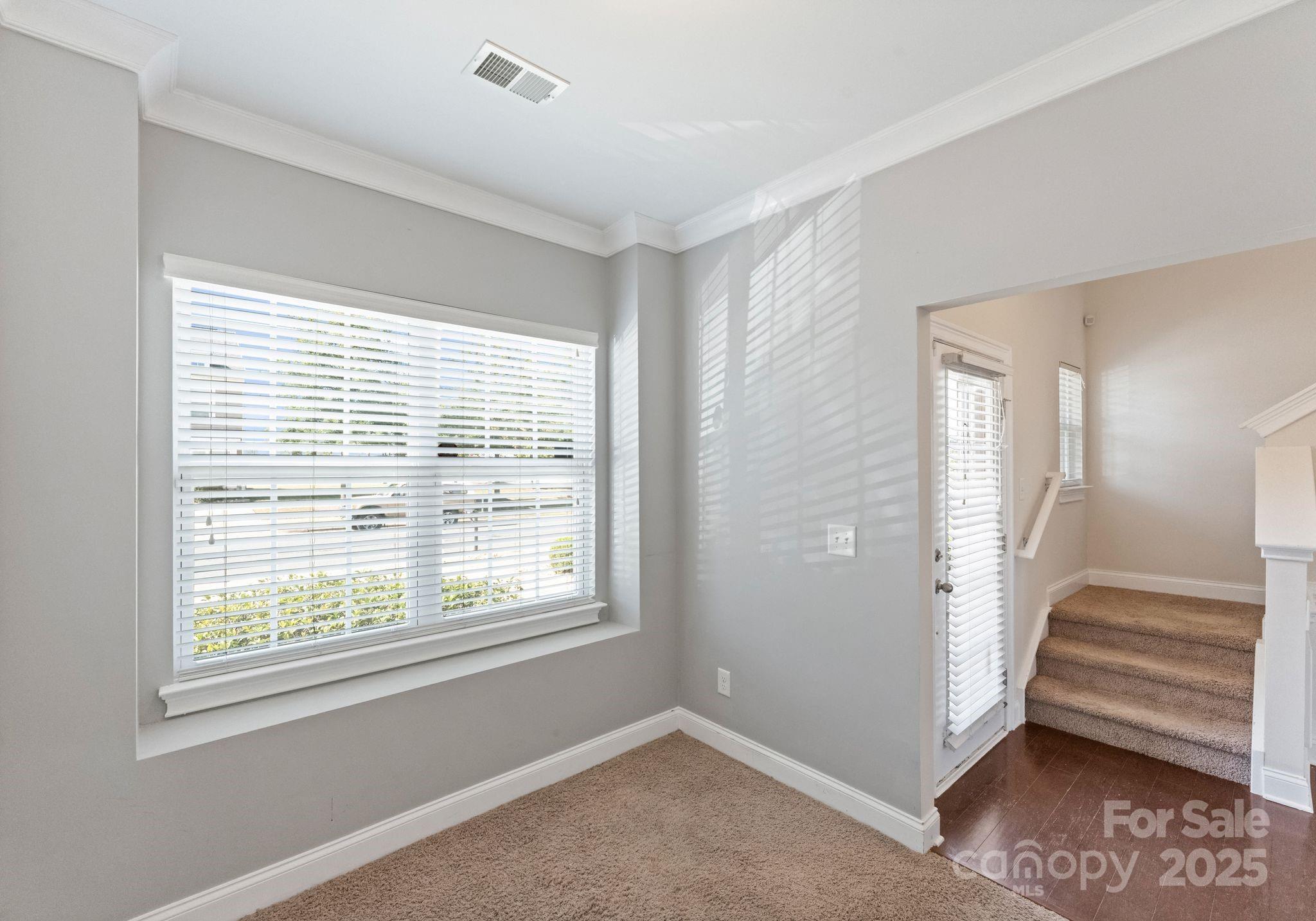 193 Halton Crossing Drive Southwest Concord, NC 28027 - Photo 13 of 20 a view of an empty room with stairs and a window