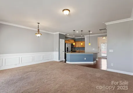 a view of an empty room with a kitchen