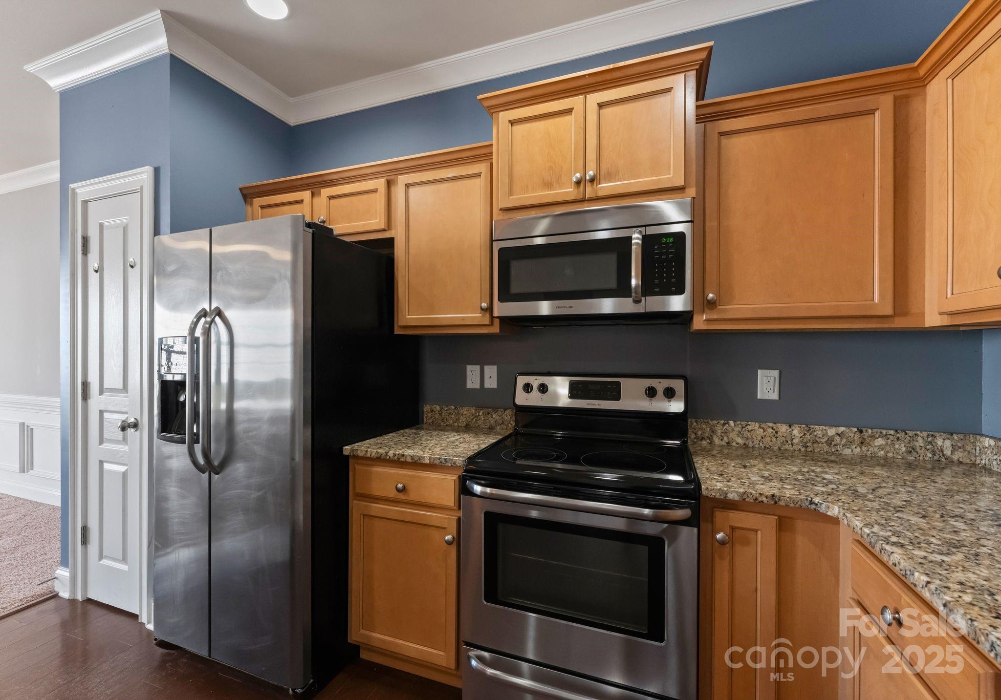 193 Halton Crossing Drive Southwest Concord, NC 28027 - Photo 10 of 20 a kitchen with stainless steel appliances granite countertop a refrigerator stove and microwave