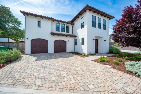 a front view of a house with a yard and a garage