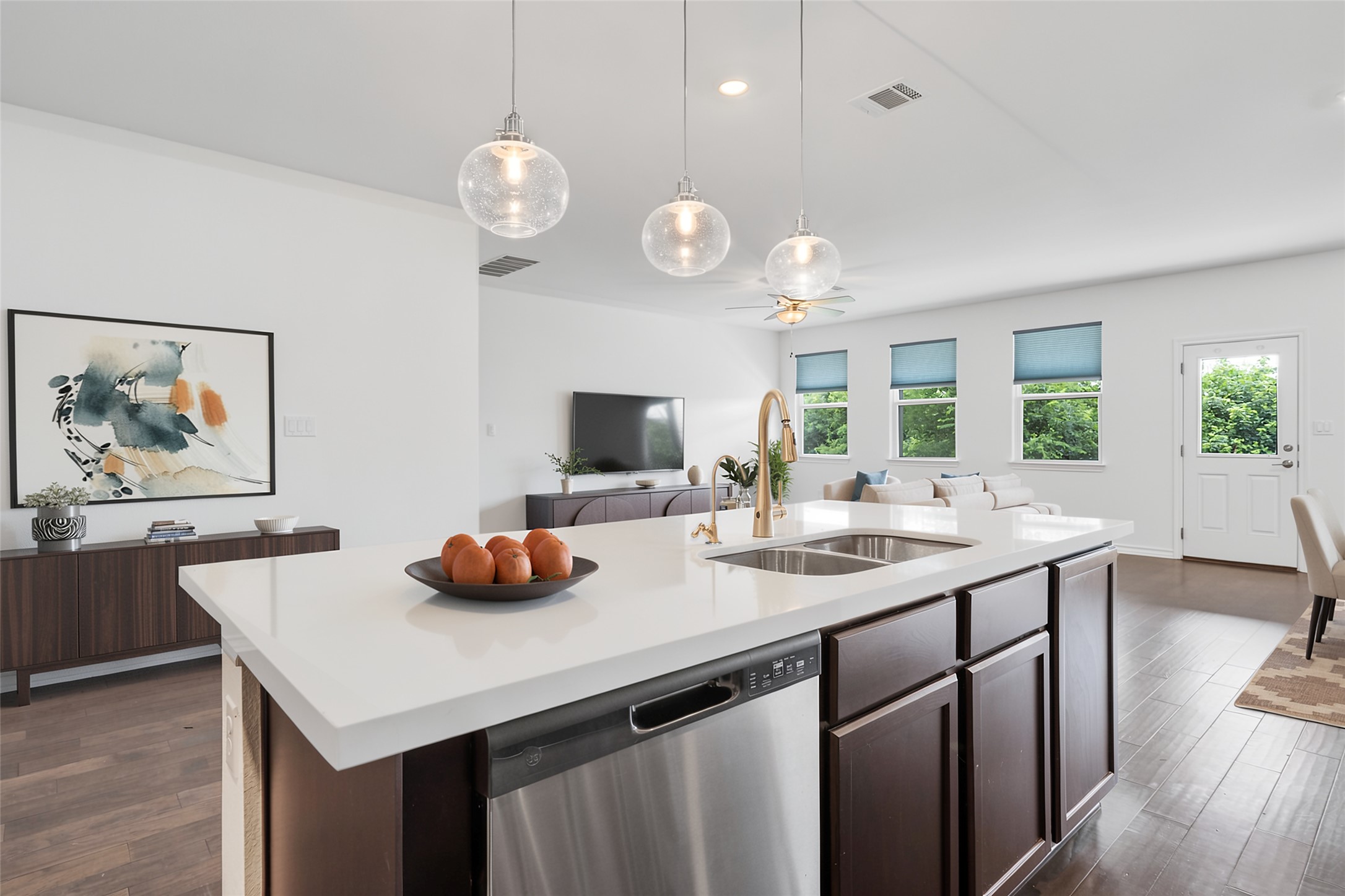 104 Stinchcomb Road Hutto, TX 78634 - Photo 10 of 40 Enjoy white quartz countertops, pendant lighting, and a large island with space for counter seating.
