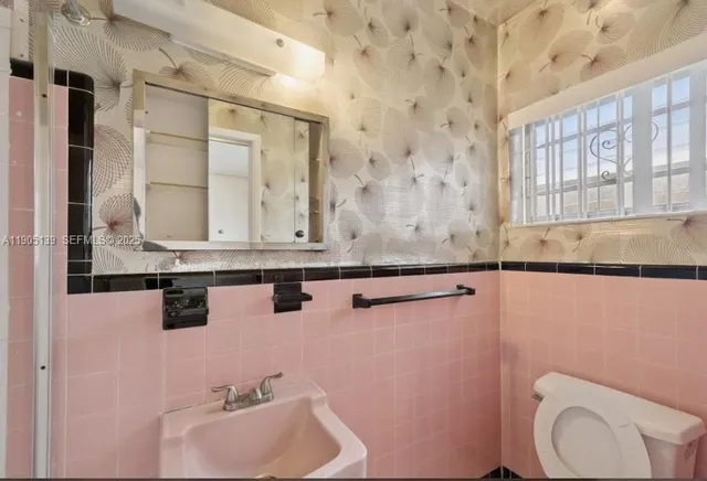 a view of a hallway with wooden floor and stairs