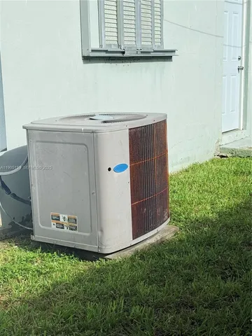 an aerial view of a house with a yard and potted plants