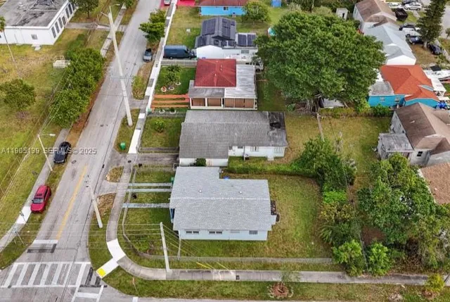 an aerial view of residential house with outdoor space and swimming pool