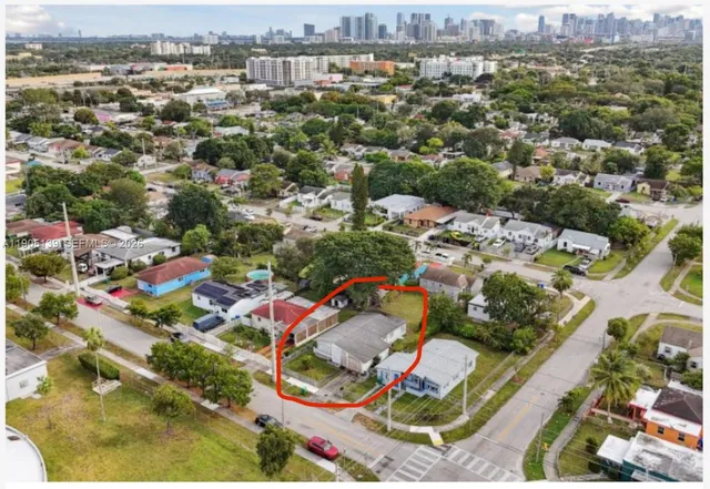 an aerial view of residential houses with city view