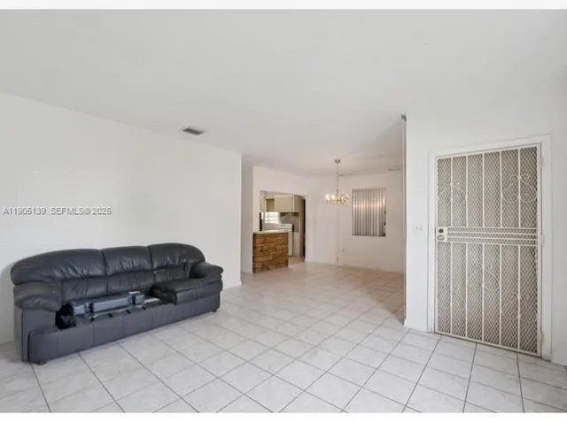 a living room with furniture and a walk in closet