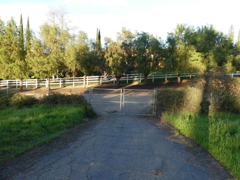 725 Yucca Road Fallbrook, CA 92028 - Photo 25 of 46 a view of a lake with a yard and a wooden fence