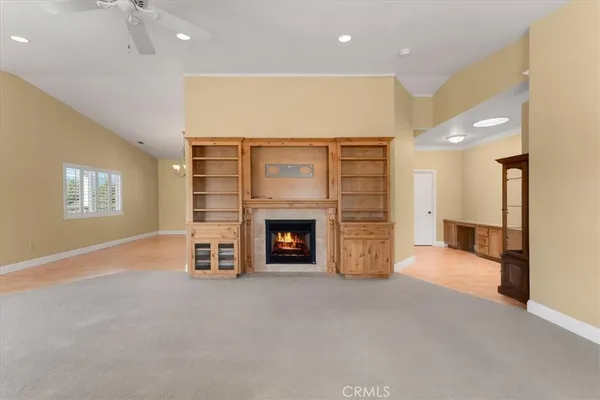 a view of a livingroom with a fireplace and window