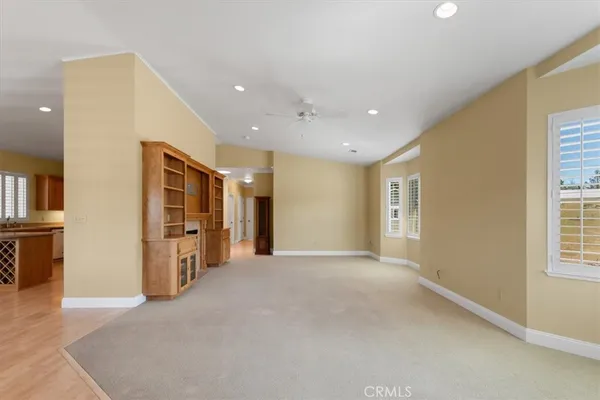 an empty room with closet and windows