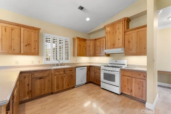 a kitchen with stainless steel appliances granite countertop a stove sink and cabinets