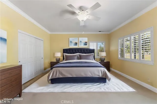 a bedroom with a large bed and a window