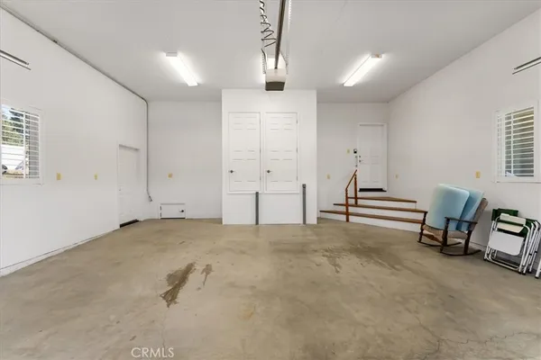 a view of a livingroom with entryway furniture and windows