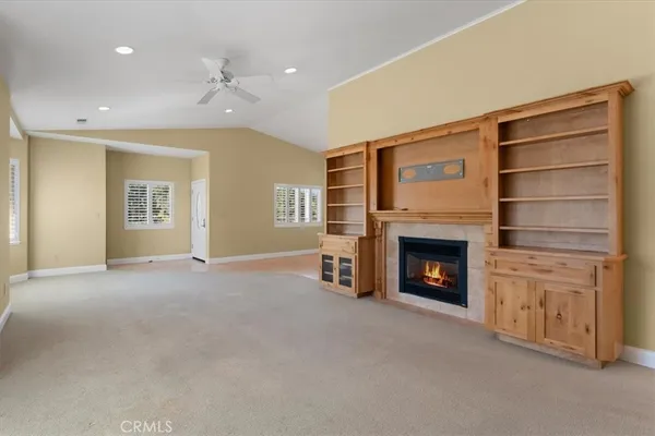 a view of a livingroom with a fireplace cabinet and window