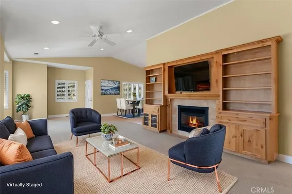 a living room with furniture fireplace and flat screen tv