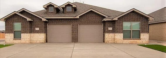 2101 Langford Avenue, Unit B Lubbock, TX 79407 - Photo 1 of 5 a front view of a house with a garage