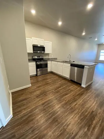 a view of kitchen with wooden floor