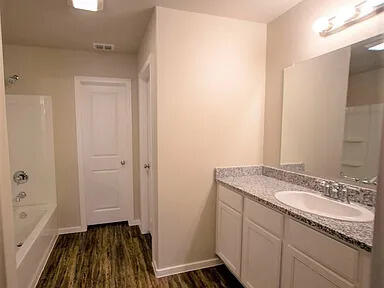 2101 Langford Avenue, Unit B Lubbock, TX 79407 - Photo 4 of 5 a bathroom with a sink and a mirror