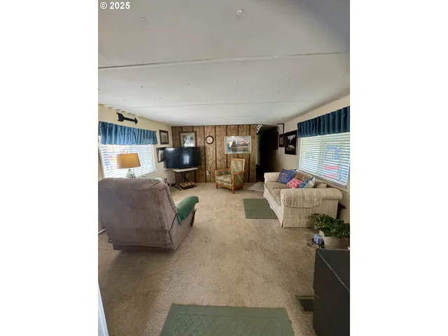 a living room with furniture and a gym machine