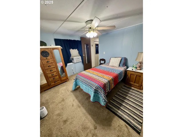 a room with a bed and a chandelier