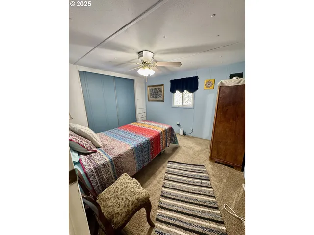 a bedroom with a bed and a chair