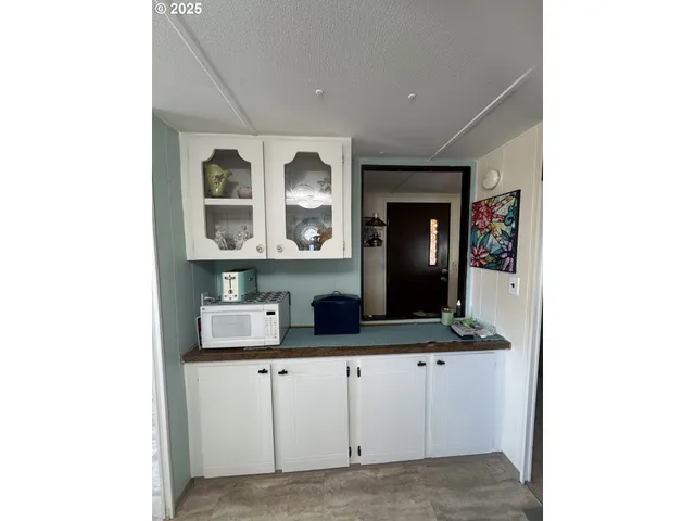 a kitchen with cabinets and window