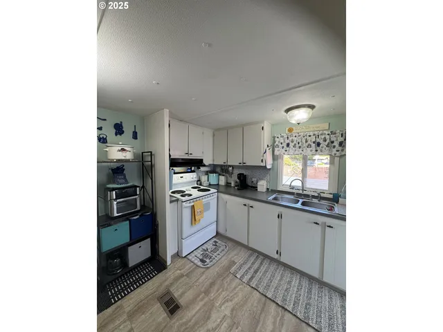 a kitchen with stainless steel appliances a sink and cabinets