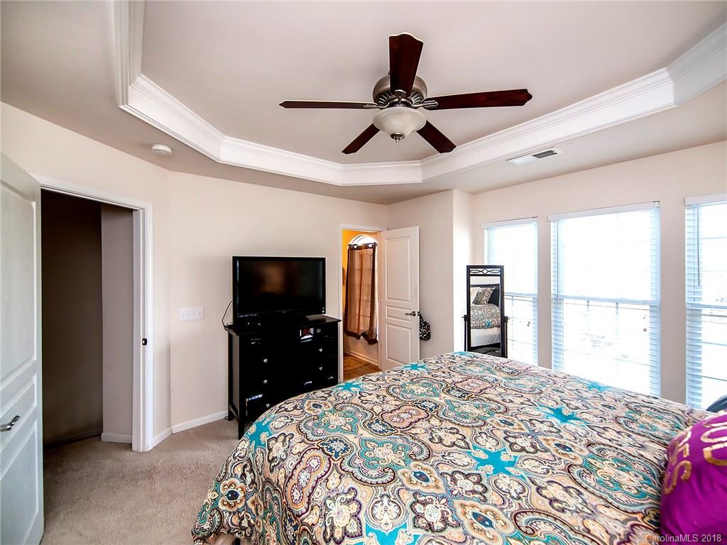 566 6th Baxter Crossing Fort Mill, SC 29708 - Photo 15 of 25 a bedroom with a bed and a flat screen tv