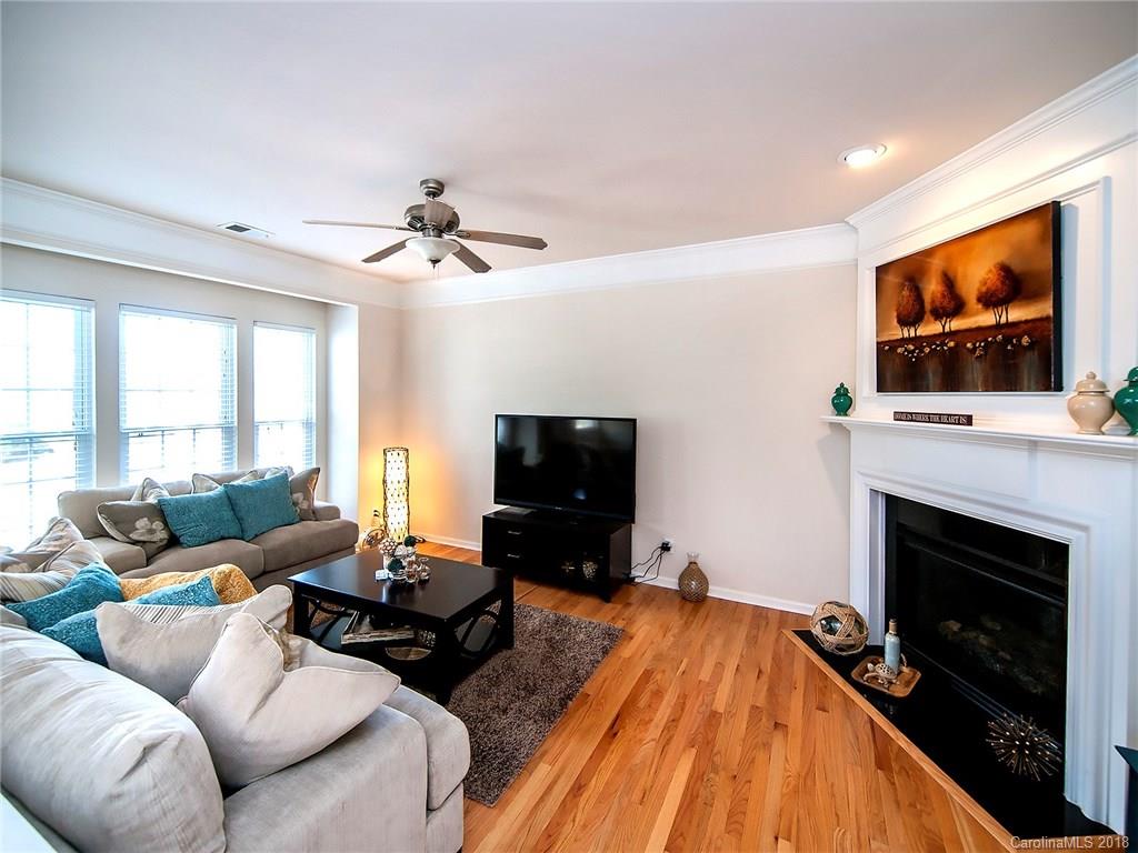 566 6th Baxter Crossing Fort Mill, SC 29708 - Photo 3 of 25 a living room with furniture a flat screen tv and a fireplace