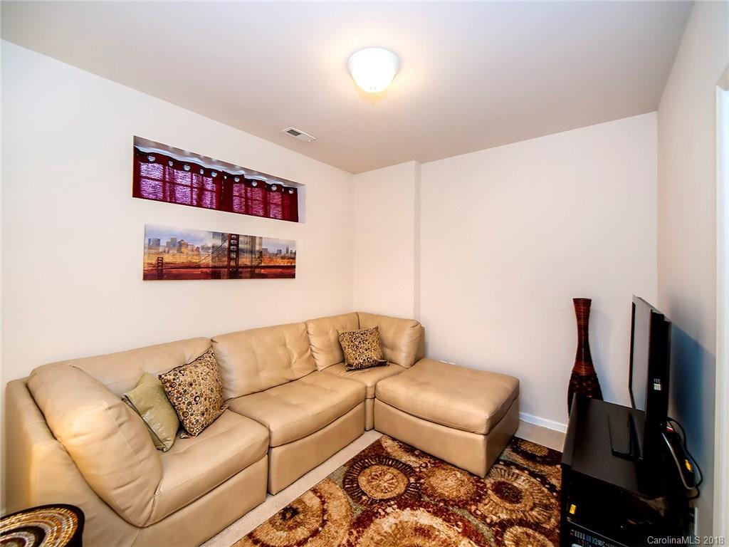 566 6th Baxter Crossing Fort Mill, SC 29708 - Photo 21 of 25 a living room with furniture and a flat screen tv