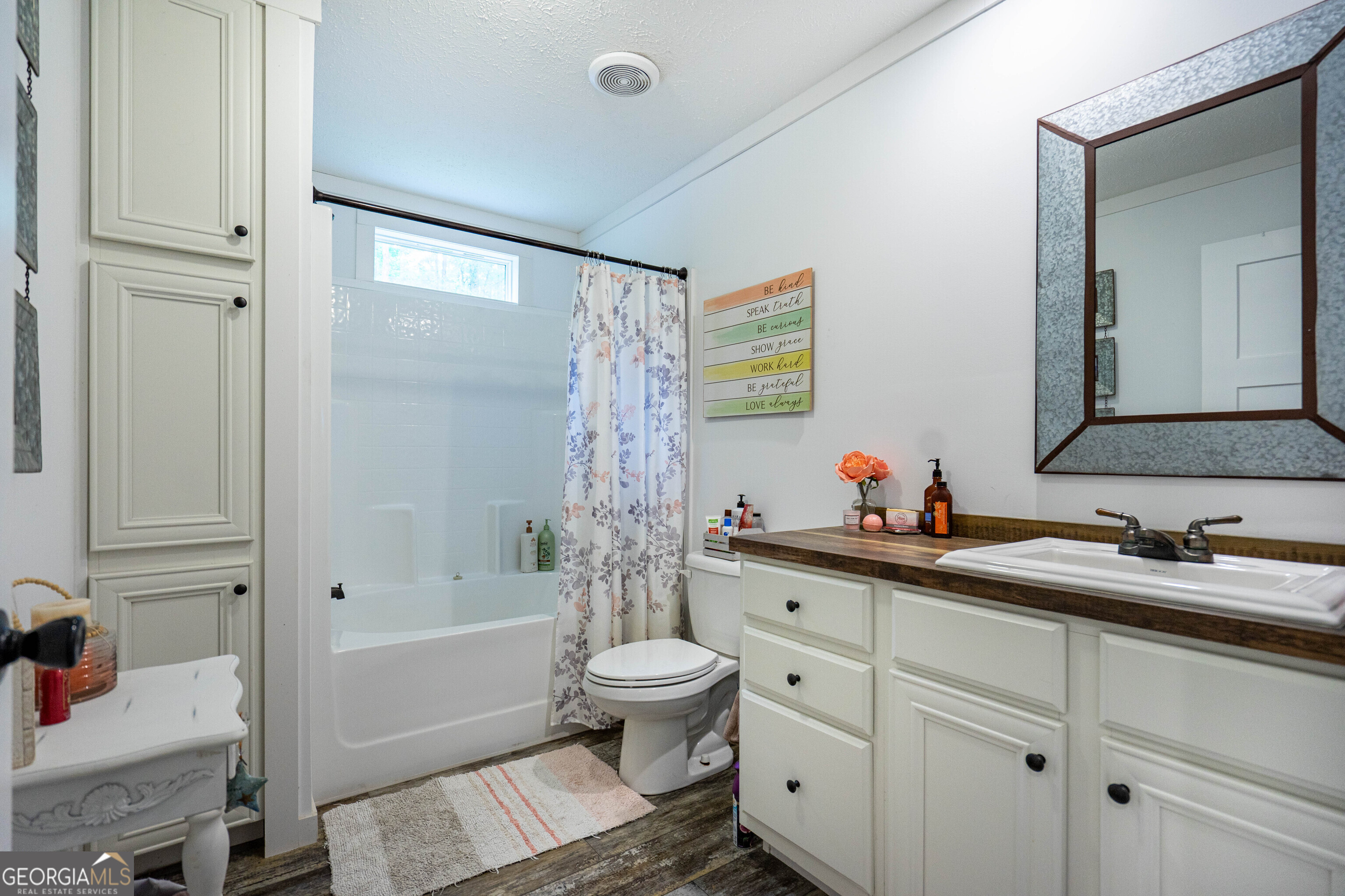 1249 County Road 446 Five Points, AL 36855 - Photo 17 of 41 a bathroom with a double vanity sink toilet mirror and shower