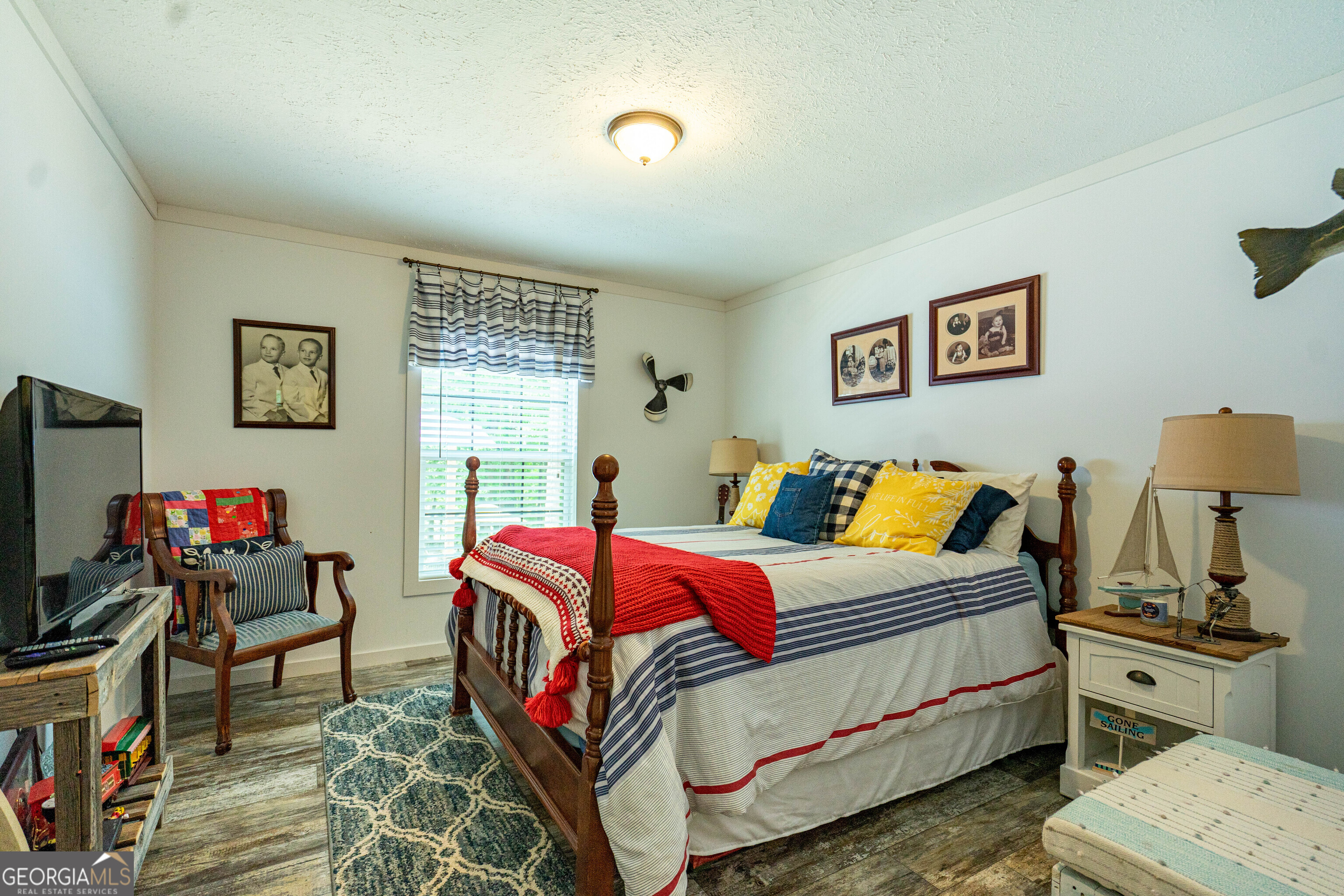 1249 County Road 446 Five Points, AL 36855 - Photo 18 of 41 a bedroom with a bed and wooden floor