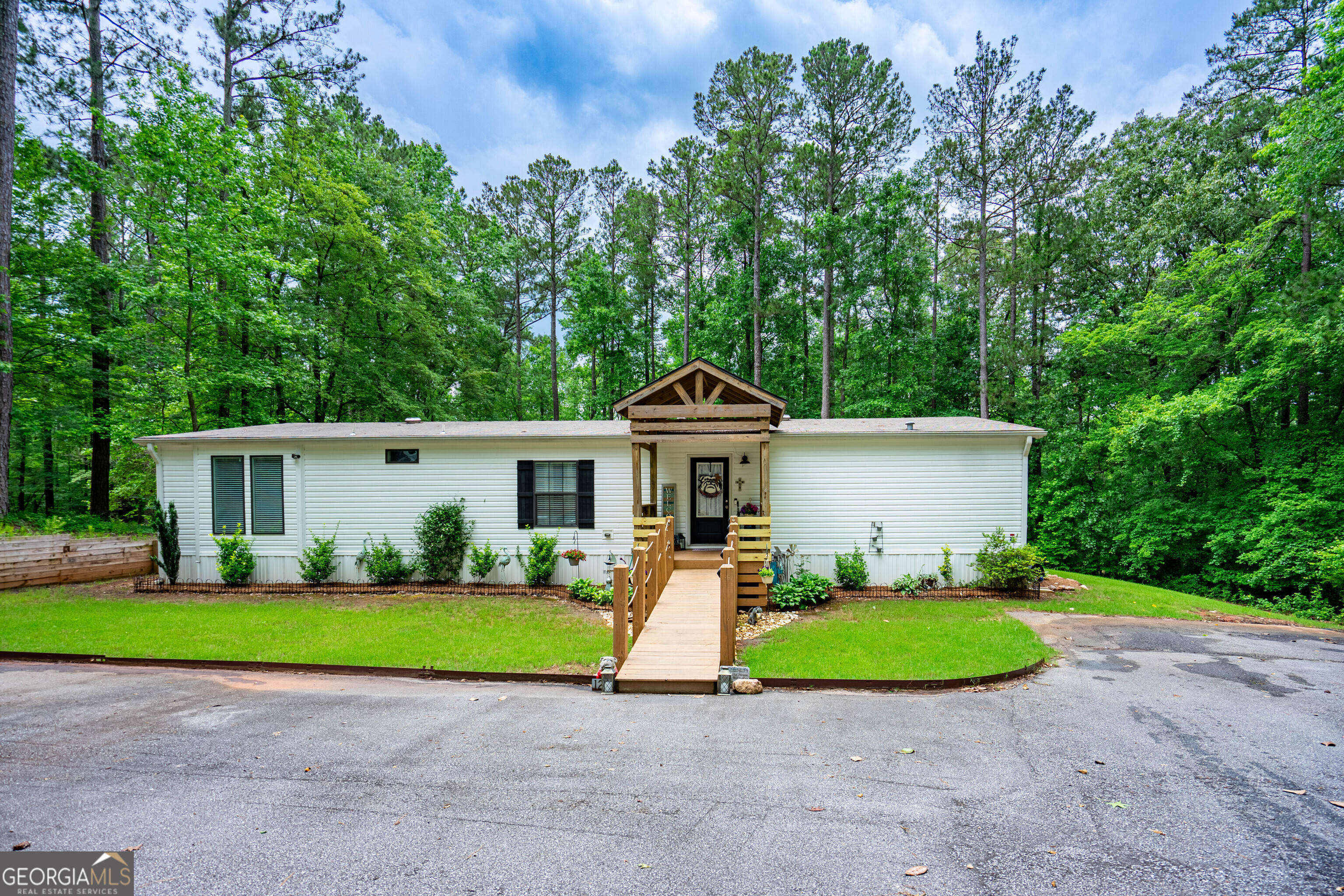 1249 County Road 446 Five Points, AL 36855 - Photo 2 of 41 a front view of a house with a yard and garage