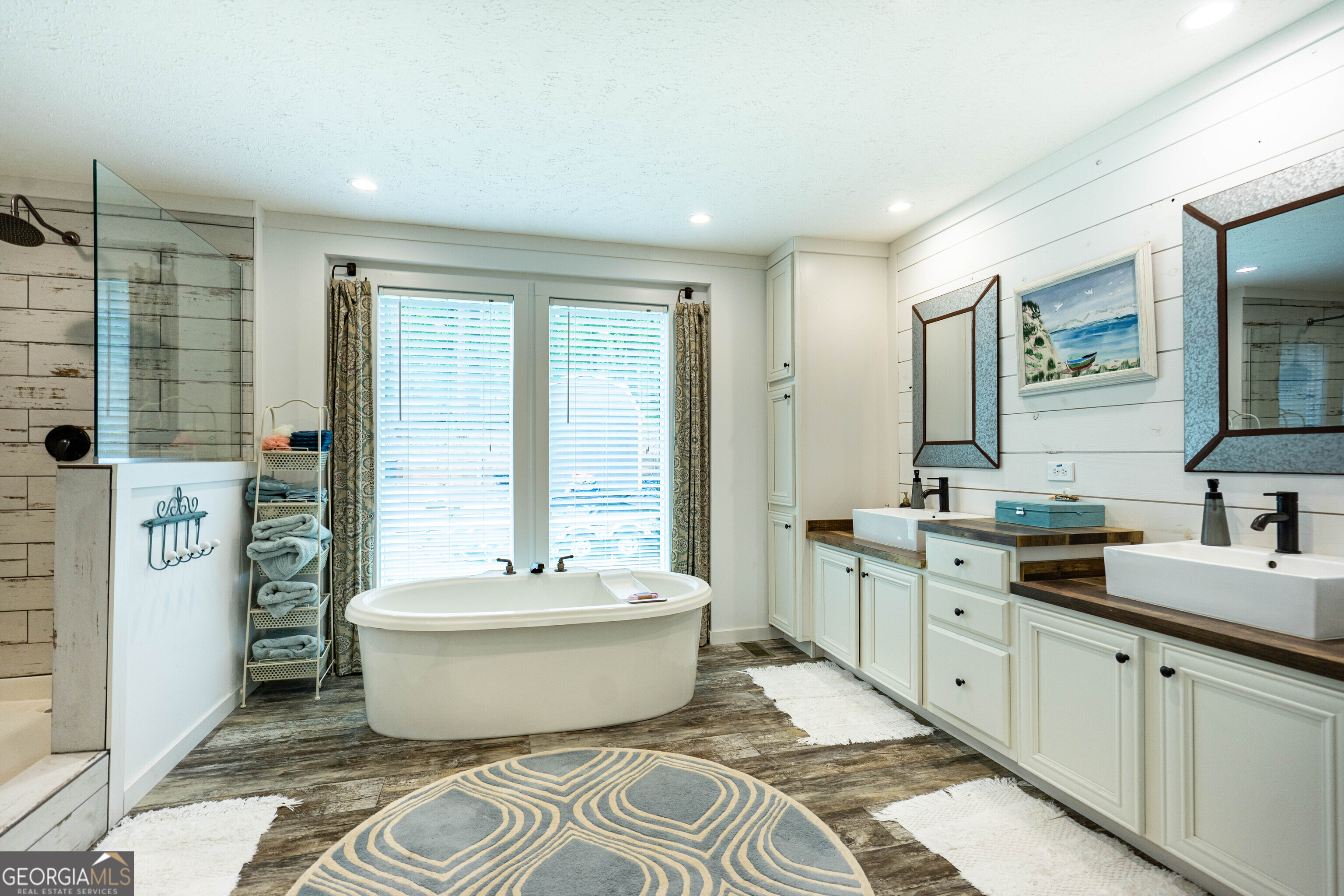 1249 County Road 446 Five Points, AL 36855 - Photo 24 of 41 a spacious bathroom with a double vanity sink a mirror and a bathtub