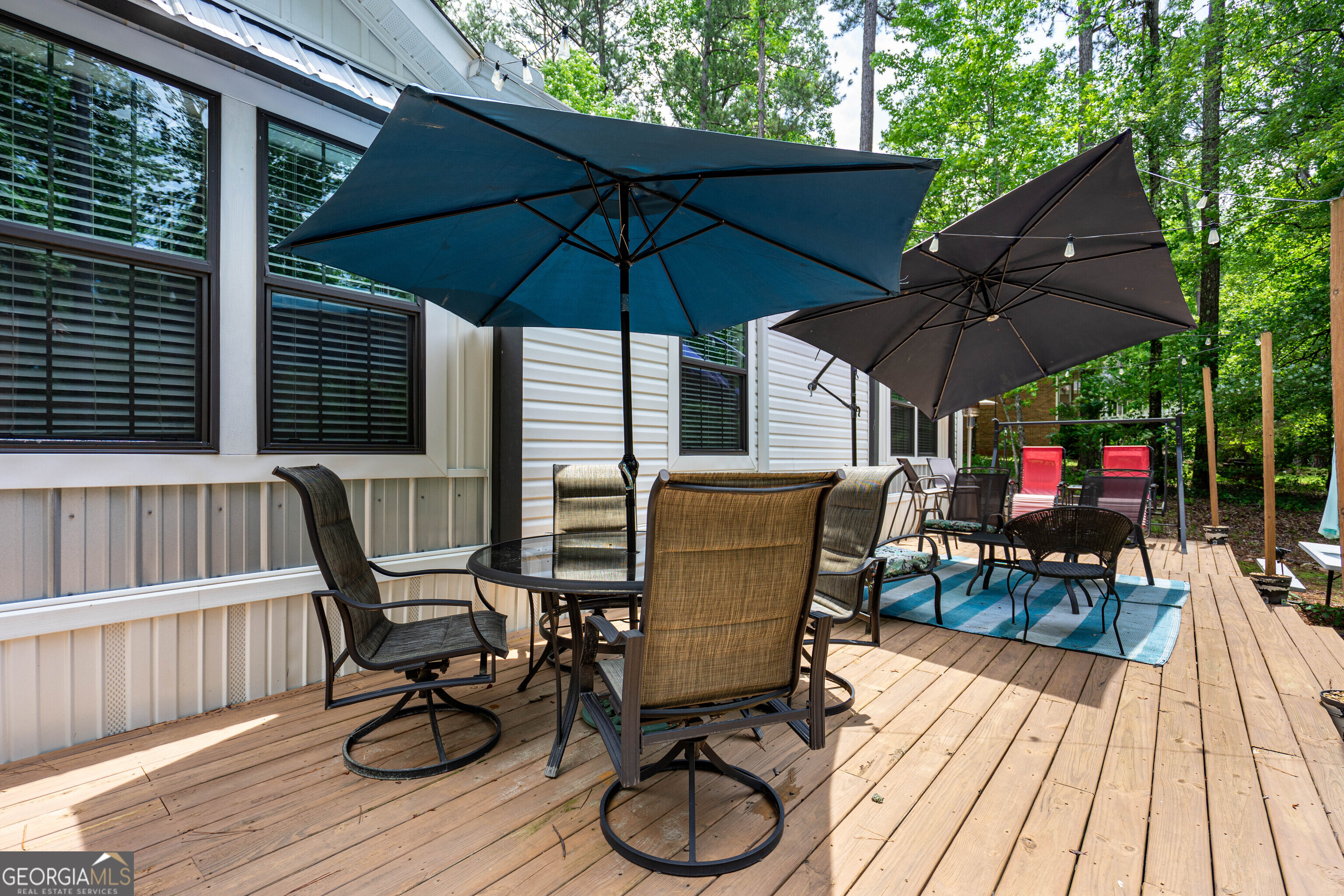 1249 County Road 446 Five Points, AL 36855 - Photo 27 of 41 a view of patio with table and chairs under an umbrella with wooden floor