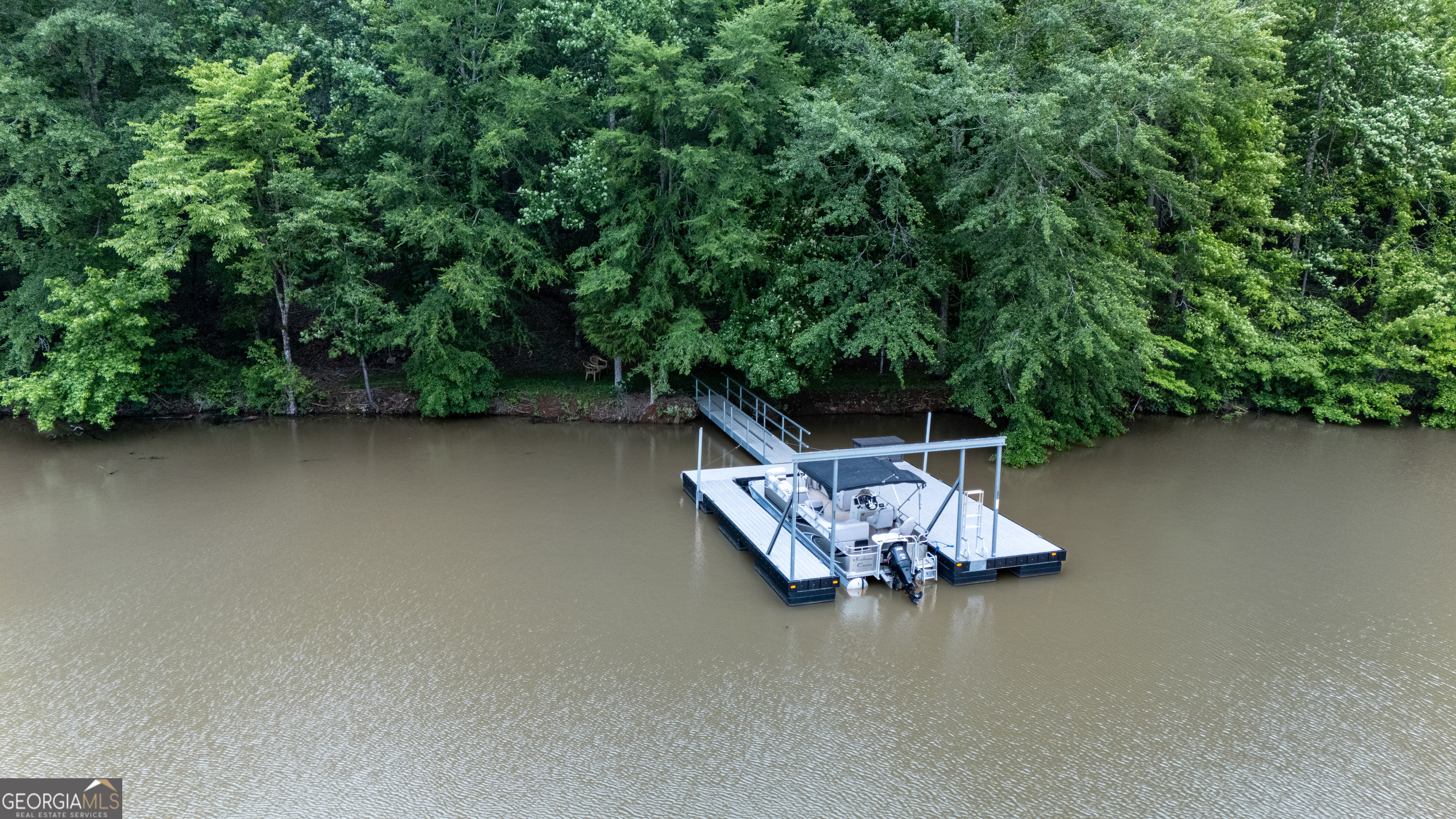 1249 County Road 446 Five Points, AL 36855 - Photo 40 of 41 a wooden bench sitting in the middle of a lake