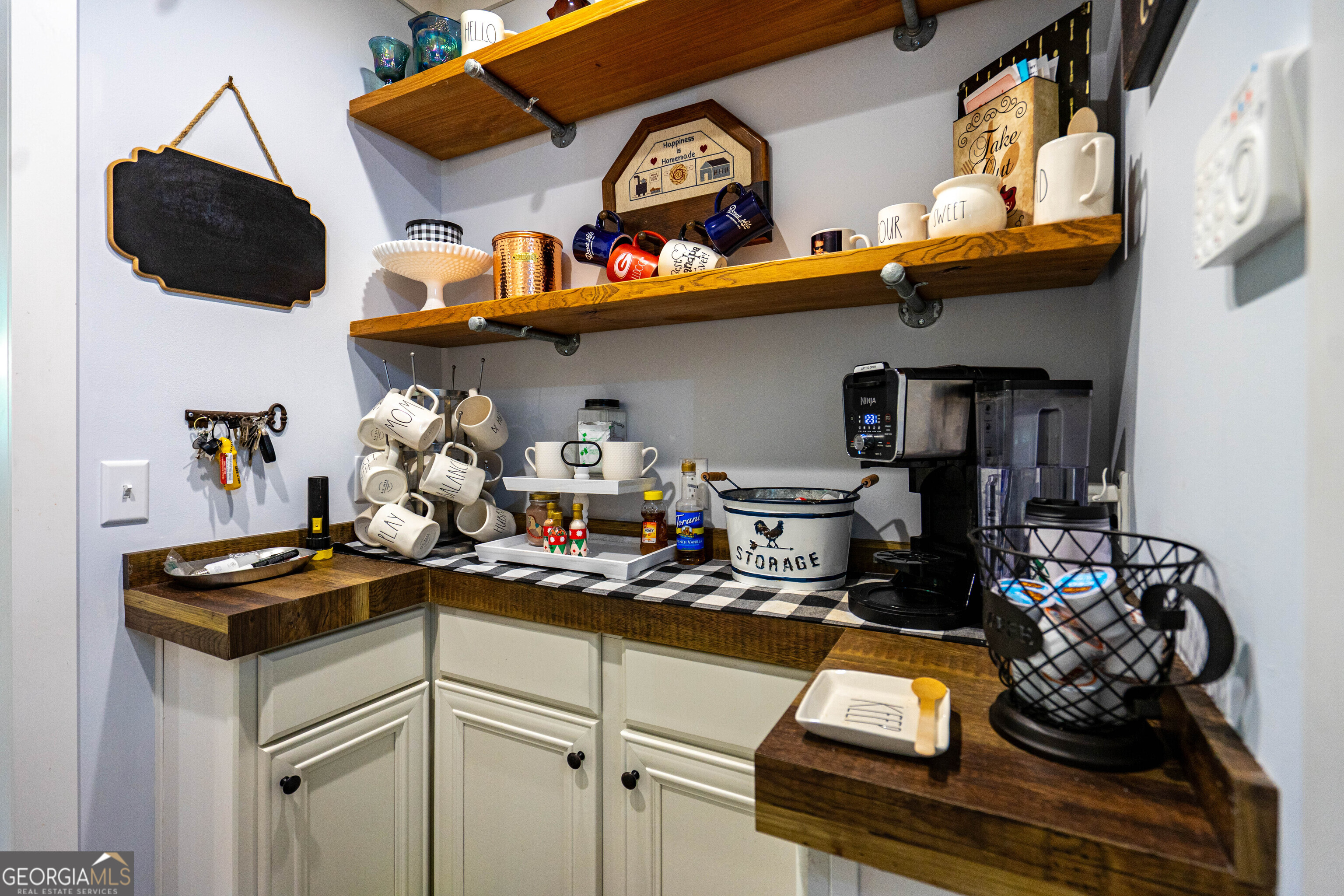 1249 County Road 446 Five Points, AL 36855 - Photo 6 of 41 a kitchen with lots of clutter and cabinets