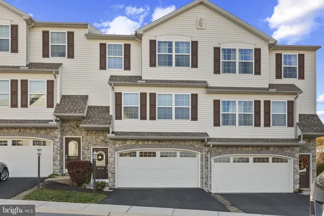 a view of a white building with large windows